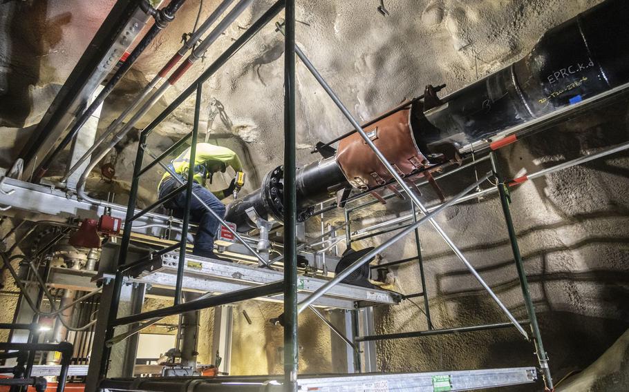 A Navy contractor works on repairing a fuel pipe at the Red Hill Bulk Fuel Storage Facility near Joint Base Pearl Harbor-Hickam, Hawaii, March 6, 2023.