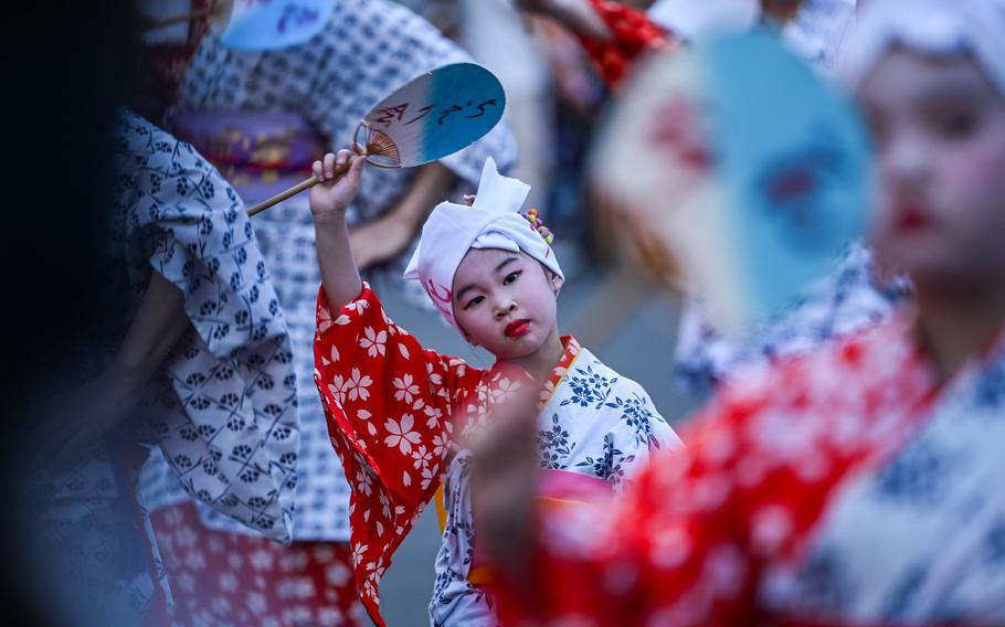 A young girl participates in the folk dance parade.