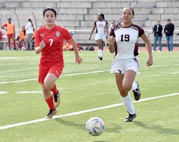 Kaiserslautern's Kimberly Guzman, left, and Vilseck's Donella Druitt go after a ball on Saturday morning at Kaiserslautern High School in Kaiserslautern, Germany.