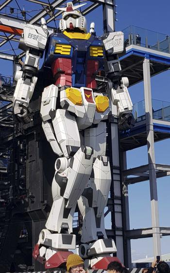 The nearly 60-foot RX-78F00 takes a step at the Gundam Factory in Yokohama, Japan.