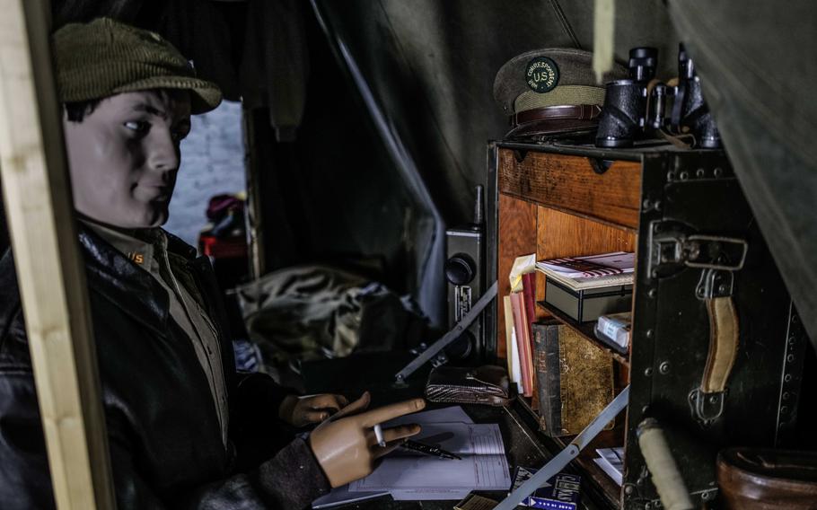 A mannequin dressed as a war correspondent sits at a typewriter in a tent, part of the 80th anniversary exhibit at Chateau Vouilly, Normandy, France. The exhibit honors the journalists who covered the D-Day invasion.
