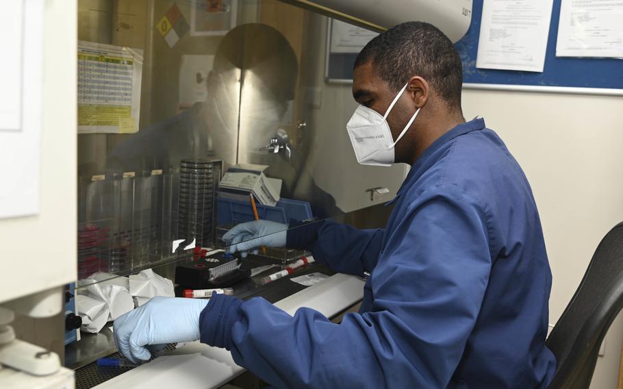 Seaman Devonta Johnson prepares COVID-19 swabs for testing at Naval Air Station Sigonella, Italy, on Feb. 15, 2022. Despite a rise in COVID-19 cases, the Italian government appeared ready to end rules requiring indoor face masks at many public places starting this weekend.