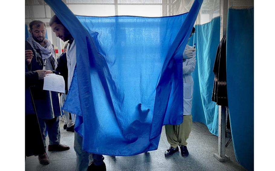 Doctors assess a patient in Kabul's increasingly crowded Jumhuriat hospital emergency ward. The collapse of health care systems across the country has sent more patients suffering from critical wounds to seek care in Afghanistan's cities. 