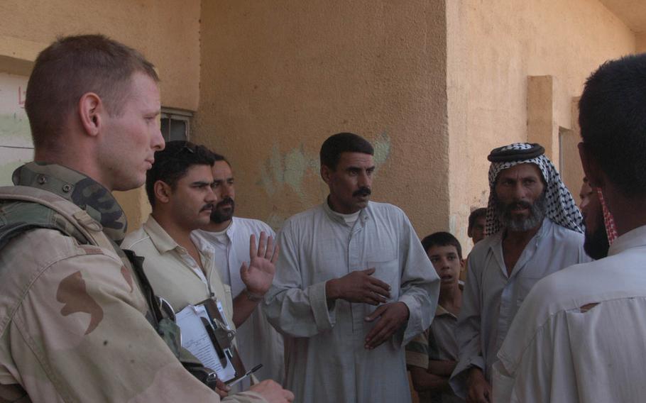 A Marine listen to men 