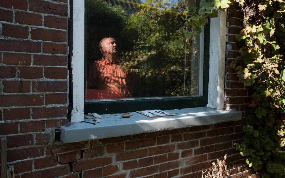 Laurens Mengerink looks at the damage at his house. The bricks, laid in 1905, have been loosened by the tremors.