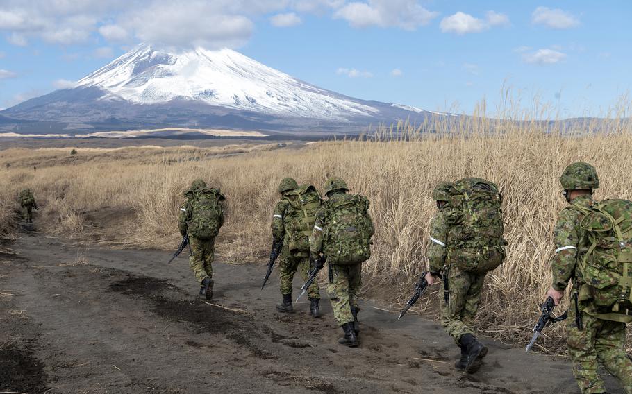 Japan Ground Self-Defense Force paratroopers assigned to the 1st Airborne Brigade maneuver near Mount Fuji, Jan. 31, 2023.