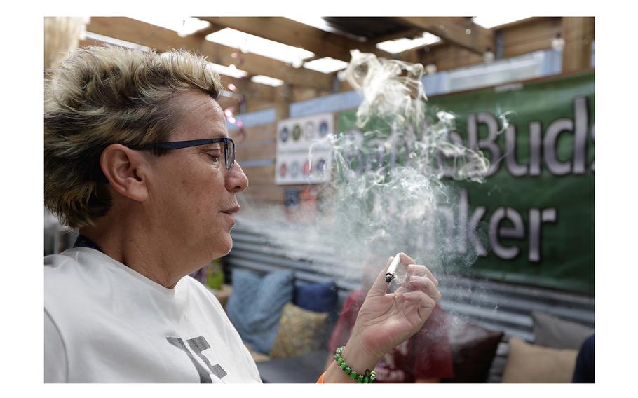Tammy Long, a 26-year Navy veteran and co-owner of BattleBuds, smokes a hemp product on March 13, 2024. in Tampa. “Some of us don’t want to get high — we want to get better. And we don’t want to go back on pills,” she said.