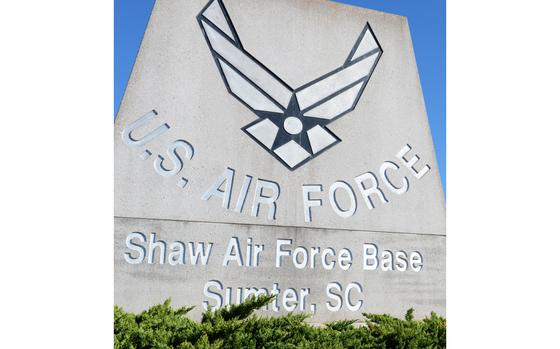 Alisha Martell, U.S. Air Forces Central collection manager, looks up at the U.S. Air Force sign on Shaw Air Force Base, S.C., March 21, 2014. Martell, who was diagnosed with cancer four times, was medically retired from the Air Force as a staff sergeant, but returned to serving as a contractor. (U.S. Air Force photo by Airman 1st Class Diana M. Cossaboom/Released)
