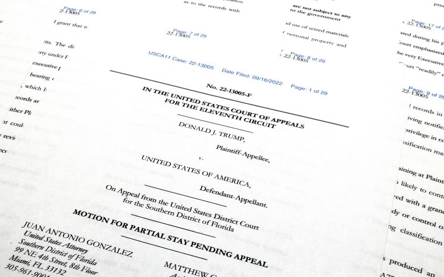 Pages from the Justice Department's motion to the 11th Circuit U.S. Court of Appeals in Atlanta are photographed Friday, Sept. 16, 2022. The Justice Department asked the federal appeals court to lift a judge's order that temporarily barred it from reviewing a batch of classified documents seized during an FBI search of former President Donald Trump's Florida home last month.