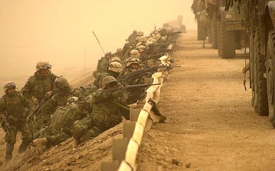 On the road to Baghdad, Iraq, March 2003: Marines line up behind a road barrier as they secure a key bridge along a main supply route during the march to Baghdad, Iraq.

META TAGS: Iraq; USMC; U.S. Marine Corps, Operation Iraqi Freedom; combat; Wars on Terror; 