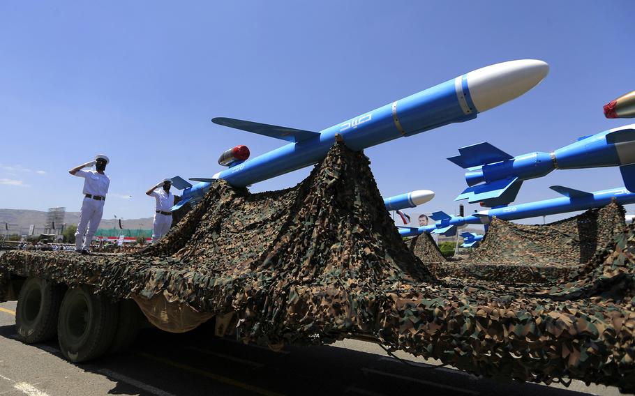Houthi soldiers stand guard on a missile carrier during an official military parade marking the ninth anniversary of the Houthi takeover of the capital, Sanaa, on Sept. 21, 2023. 