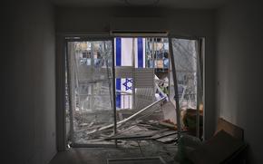 An Israeli flag is hung outside a damaged apartment two days after it was struck by a missile launched from Iran, in Ramat Gan, Israel, on Saturday, June 21, 2025. (AP Photo/Ohad Zwigenberg)