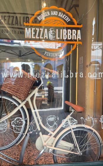 A cruiser bicycle is displayed in the seating area of Mezza Libbra Burger and Bakery in Pordenone, Italy, on Feb. 2, 2024. 