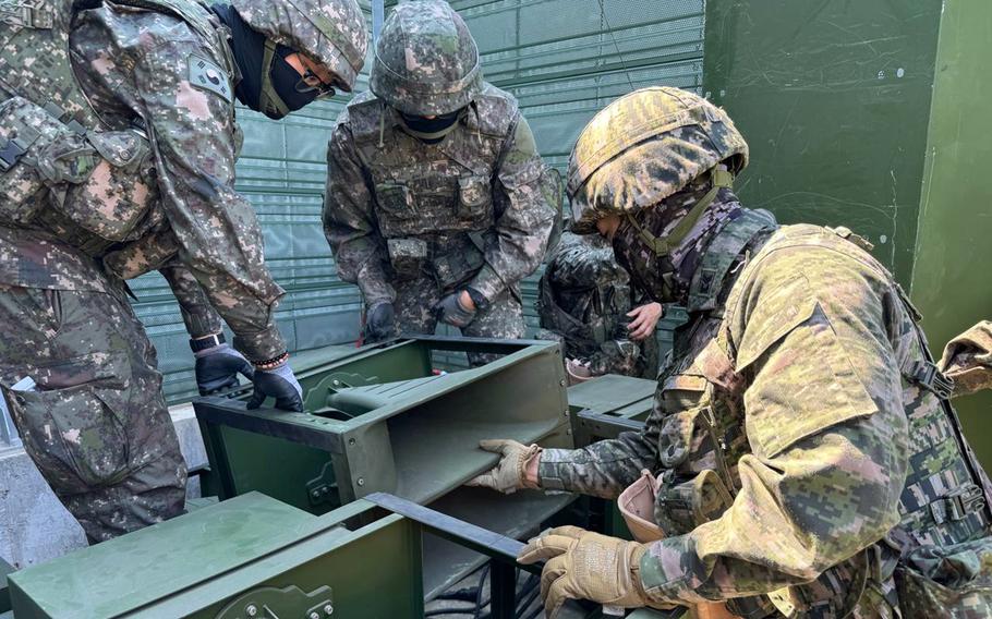 South Korean soldiers inspect loudspeaker equipment.