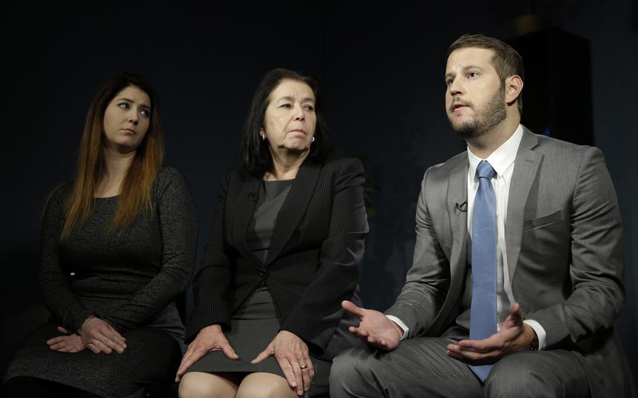 Three people sitting.