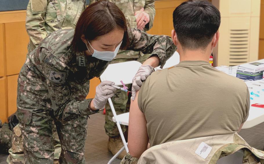 South Korean army Capt. Yeon Ju Oh administers a Moderna coronavirus vaccine to a Korean Augmentation to the U.S. Army soldier at Yongsan Garrison, South Korea, on Feb. 25, 2021.