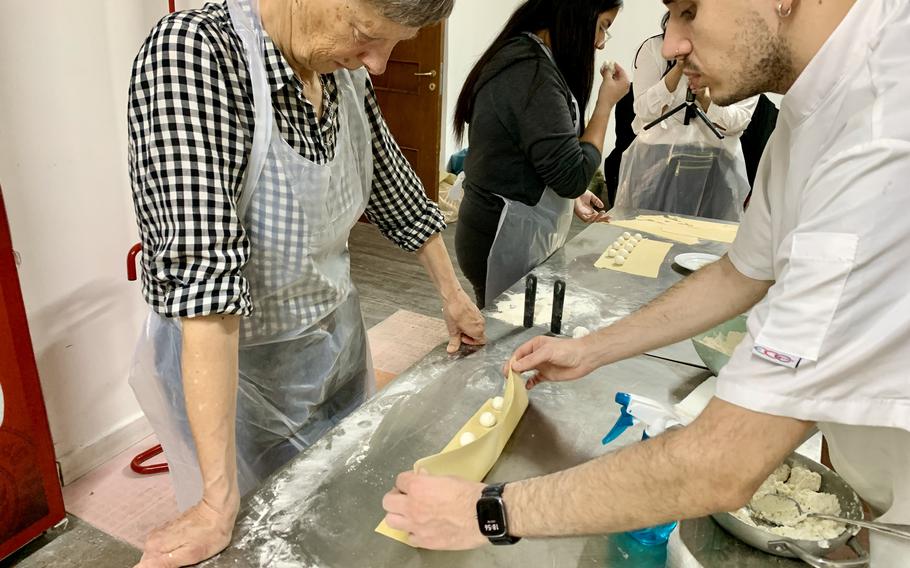 An instructor folds pasta