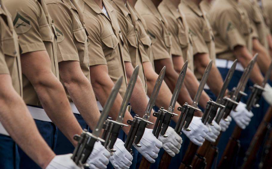 The U.S. Marine Corps Silent drill team prepares to perform during the 32nd annual United States Marine Corps Enlisted Awards Parade and Presentation held at Lejeune Hall, Marine Corps Base Quantico, Va., Sept. 24, 2014. The Corps' enlisted forces would drop from 159,716 troops to 156,650 in plans outlined in the 2022 budget.