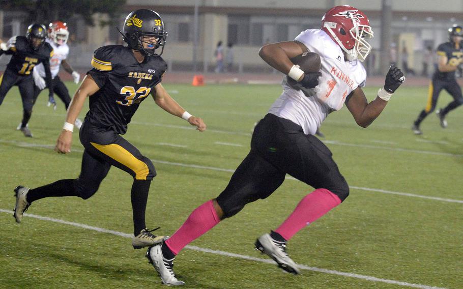 Nile C. Kinnick's Devin Jackson tries to elude Kadena's Austin Lutz.