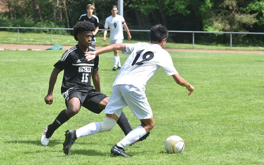 Vicenza's Tre'Vani Bradshaw tries to stay in front of Naples' Tommy Egan in the DODEA-Europe boys Division II soccer championships at Landstuhl, Germany.