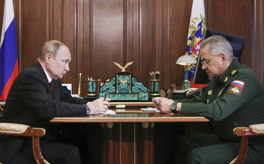 Russian President Vladimir Putin listens to Russian Defense Minister Sergei Shoigu’s report during their meeting in the Kremlin in Moscow, Russia, July 4, 2022. Shoigu said Sept. 21, 2022, following Putin’s address to the nation, that Russia would call as many as 300,000 reservists to military service. 