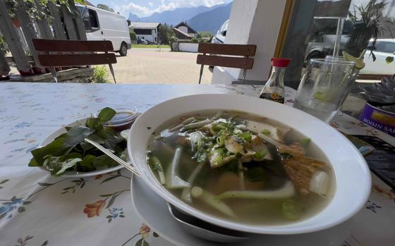 A bowl of pho served with mint, lime and fish sauce at Bun Viet in Unterammergau, Germany, Sept. 8, 2023.