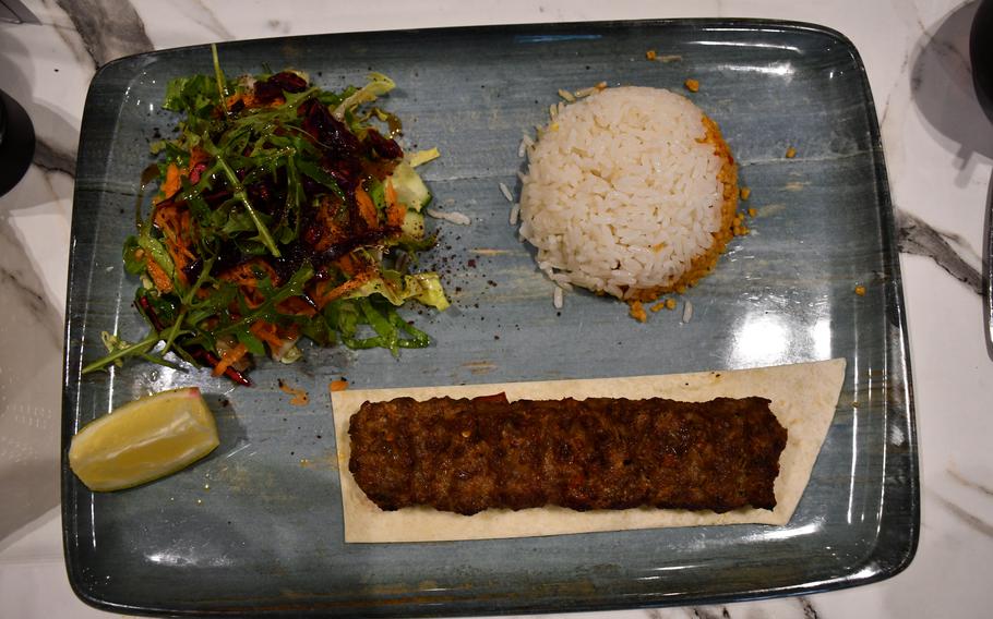 Turkoman Bar and Grill's Adana kofte as served May 9, 2023. The dish features grilled minced lamb seasoned with parsley and red pepper flakes, served with rice.