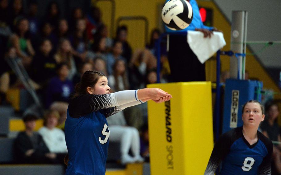 Brussels’ Patricia Rullan hits the ball as teammate Taegan Muller watches in the Brigands’ 25-21, 17-25, 25-20, 25, 20,  loss to Ansbach in the Division III final at the DODEA-Europe volleyball championships at Ramstein, Germany, Oct. 28, 2023.