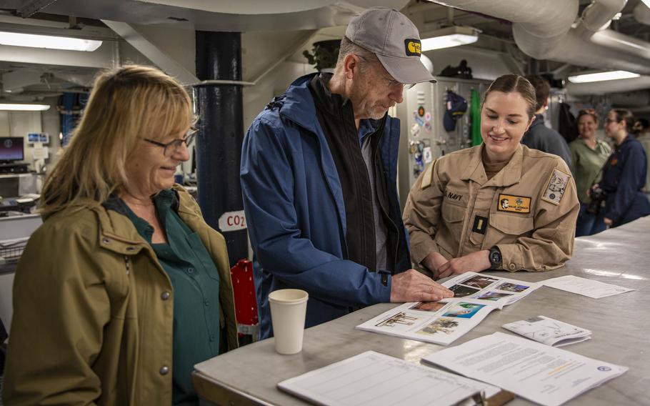 Sailors and guests tour spaces aboard the USS Abraham Lincoln