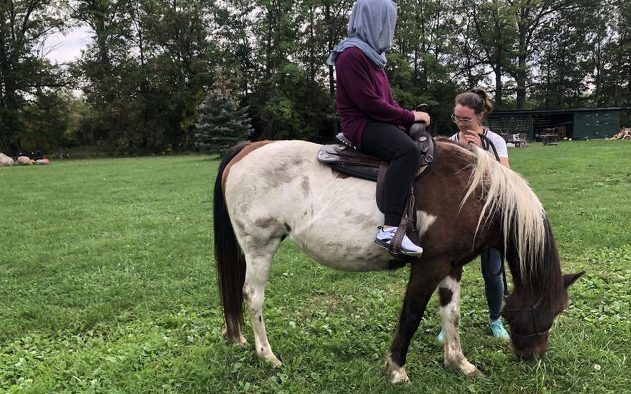 Mursal rides a horse at HideOut Pines Ranch in Sheffield, Ohio.