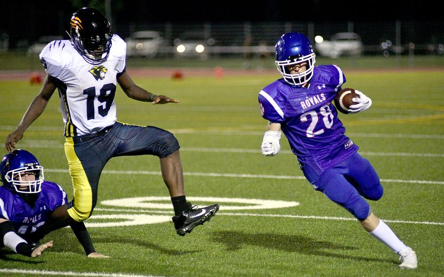 Royal running back Ethan Wilson turns the corner while Stuttgart defender Nathan Clery chases during a Sept. 8, 2023, game at Ramstein High School on Ramstein Air Base, Germany.