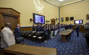 Future airmen raise their hands as they are sworn in.