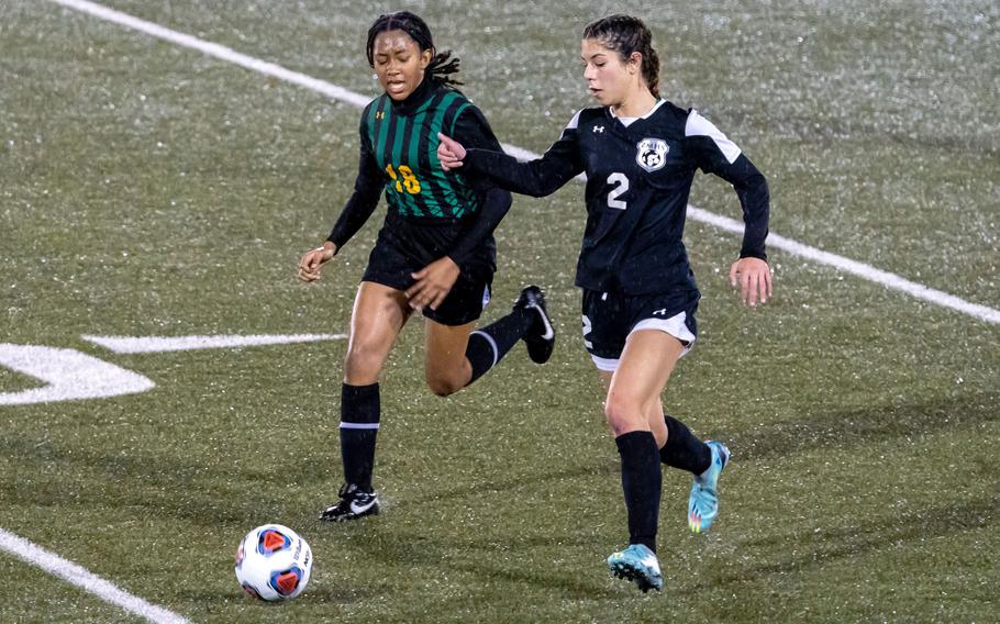Robert D. Edgren's Nia Tyler and Zama's Isabella Rivera chase the ball during Friday's DODEA-Japan girls soccer match. The Eagles won 2-0, their first win in eight matches this season.