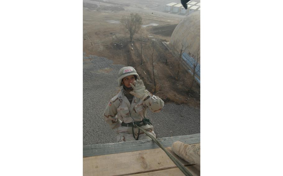 Pfc. Hinemoa Kekoa raises her hand to show the instructor that she is properly guiding herself down the rappelling tower at the 101st Airborne Division’s air assault school at Qayyarah West Air Field in northern Iraq. Kekoa, 22, from Waipahu, Hawaii, is an automated supply specialist with B Company, 426th Forward Support Battalion, 1st Brigade Combat Team.