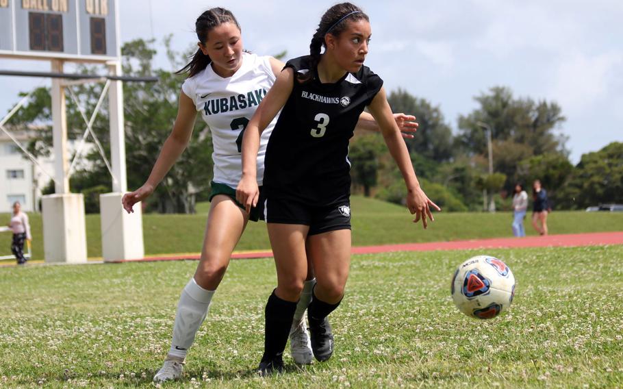 Former teammates, now foes. Humphreys' Syra Soto keeps the ball away from Kubasaki's Erika Samluk during Monday's Division I girls soccer match. Samluk and the Dragons beat the former Dragon Soto and the Blackhawks 6-0.