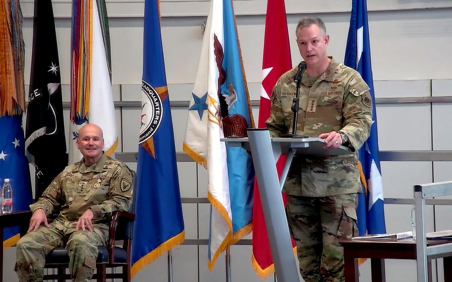 Gen. Christopher Cavoli listens to incoming commander Gen. Alexus Grynkewich speak during a change of command.