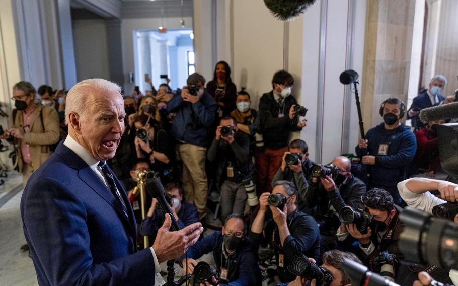 President Joe Biden speaks to members of the media as he leaves a meeting with the Senate Democratic Caucus to discuss voting rights and election integrity on Capitol Hill in Washington, Thursday, Jan. 13, 2022.