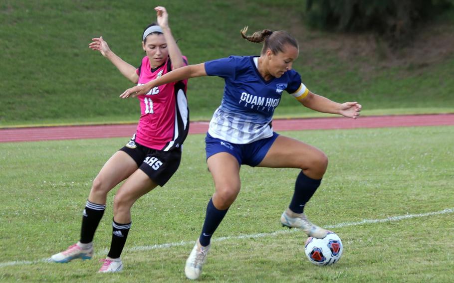 Kadena's Baylee Smith and Guam High's Zoie Terril chase the ball during Monday's Division I girls soccer match. Kadena won the all-Panthers battle 4-1.