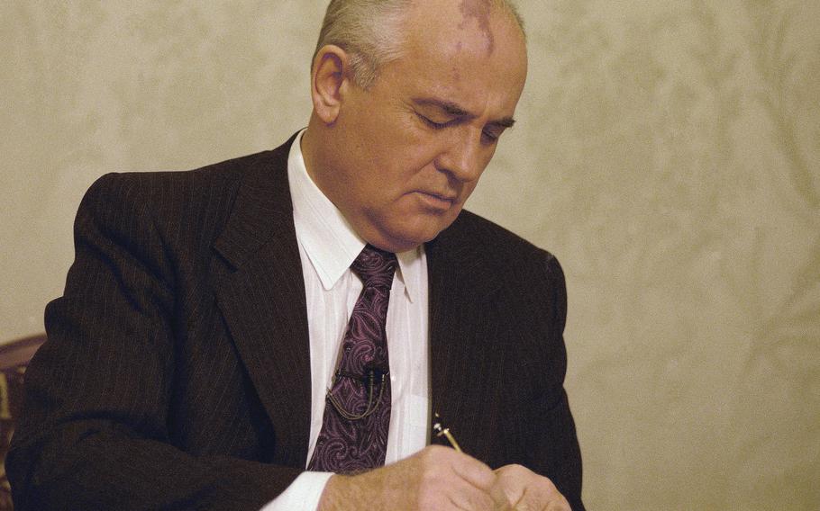 Mikhail Gorbachev, the final leader of the Soviet Union, signs the decree relinquishing control of nuclear weapons to Boris Yeltsin at the Kremlin in Moscow, Wednesday, Dec. 25, 1991. Gorbachev announced his resignation in a live televised address to the nation on Dec. 25, 1991, drawing a line under more than 74 years of Soviet history. 