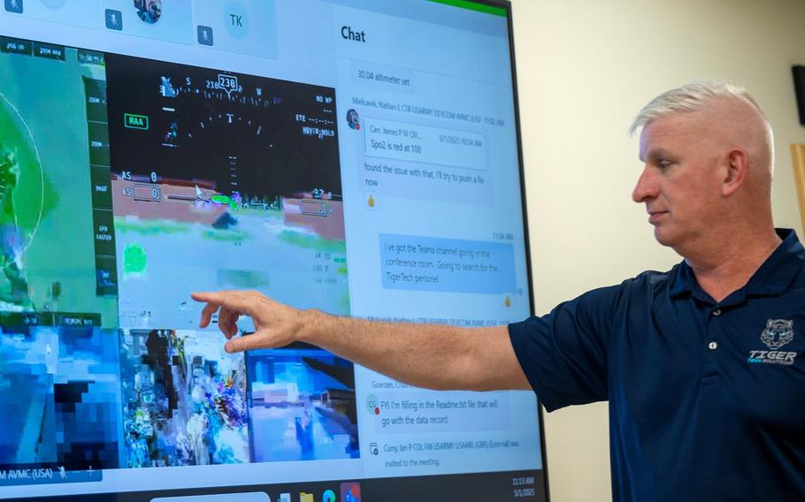 A man points to an image on a screen.