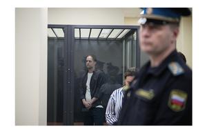 Wall Street Journal reporter Evan Gershkovich stands in a glass cage in a courtroom at the First Appeals Court of General Jurisdiction in Moscow, Russia, Tuesday, April 23, 2024. 