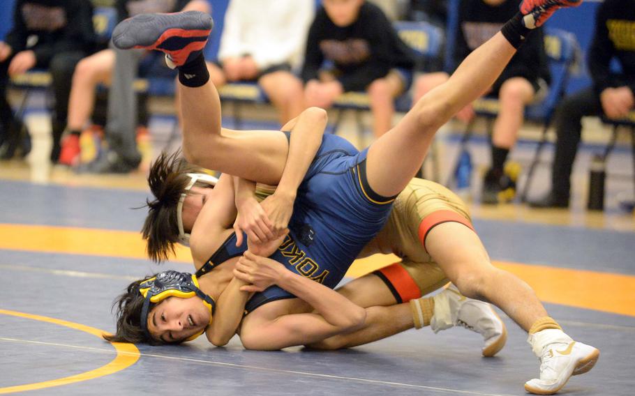 Yokota 107-pounder Jay Gutierrez gets caught in a cradle by St. Mary's Hugo Miyamoto during Wednesday's Kanto Plain dual meet. Miyamoto won by pin in 27 seconds and the Titans won the meet 40-18.