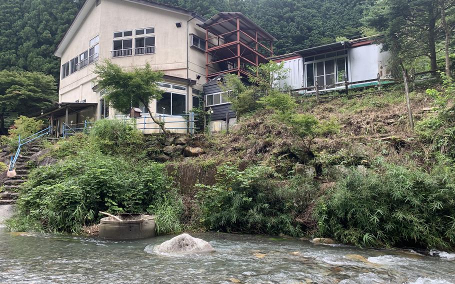 Steps lead from the main guesthouse down to the Kuro River at the Earth Hostel near Nikko, Japan.