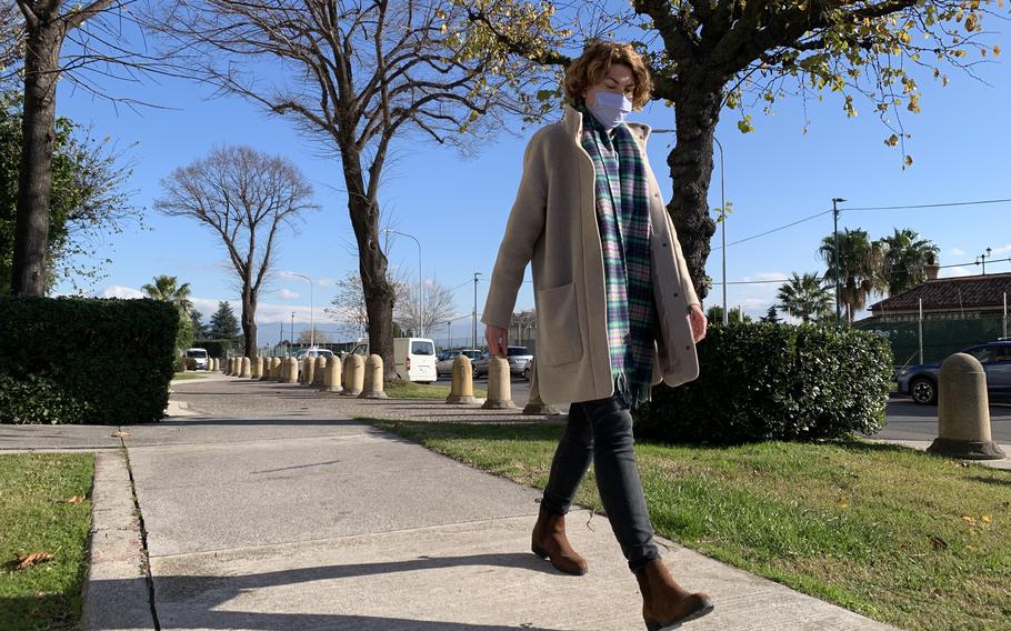 Rebecca Armbrister, who is married to a U.S. sailor assigned to Naval Support Activity Naples, walks during her lunch break at the base's Capodichino site on Dec. 16, 2021. Armbrister considers herself lucky to find a full-time job on base that suits her skills. But Armbrister says she knows many military spouses who don't have that opportunity. 