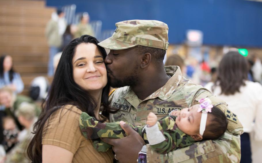 Sgt. Mitch Thompson, a unit supply specialist assigned to C Company, 1st Battalion, 12th Infantry Regiment, 2nd Stryker Brigade Combat Team, 4th Infantry Division, greets his newborn daughter for the first time, at Fort Carson, Colo., Tuesday, March 5, 2024. While Thompson was deployed to Korea for a nine-month training rotation, his child was born, waiting to meet him when he returned home.