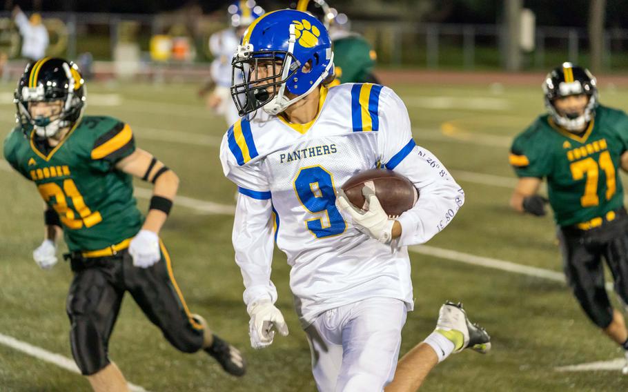 Yokota's Tate Rannow dashes around left end against Robert D. Edgren; he finished with 99 yards on six carries with a touchdown.