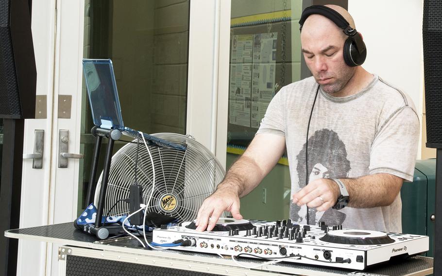 DJ Darrick D, also known as Lt. Col. Darrick Duran, plays "Lovely Day" by Bill Withers on the first day of classes at Yokota Air Base, Japan, Aug. 21, 2023.