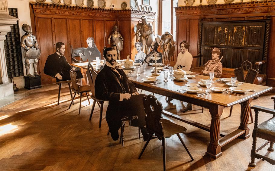 Ghostlike cutouts are situated around a dining room table at Reichenstein Castle. The castle was owned by the Kirsch-Puricelli family.