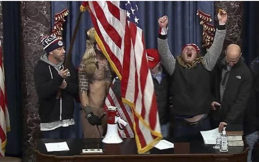 Tommy Frederick Allan, left, is seen in the U.S. Capitol on Jan. 6, 2021.