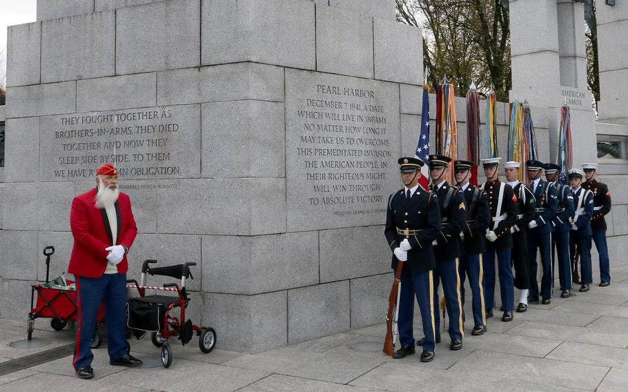 Veteran Steve Kovalchik of Silver Spring, Md., and the Armed Forces Color Guard await the start of the Veterans Day ceremony at the National World War II Memorial in Washington, November 11, 2023.